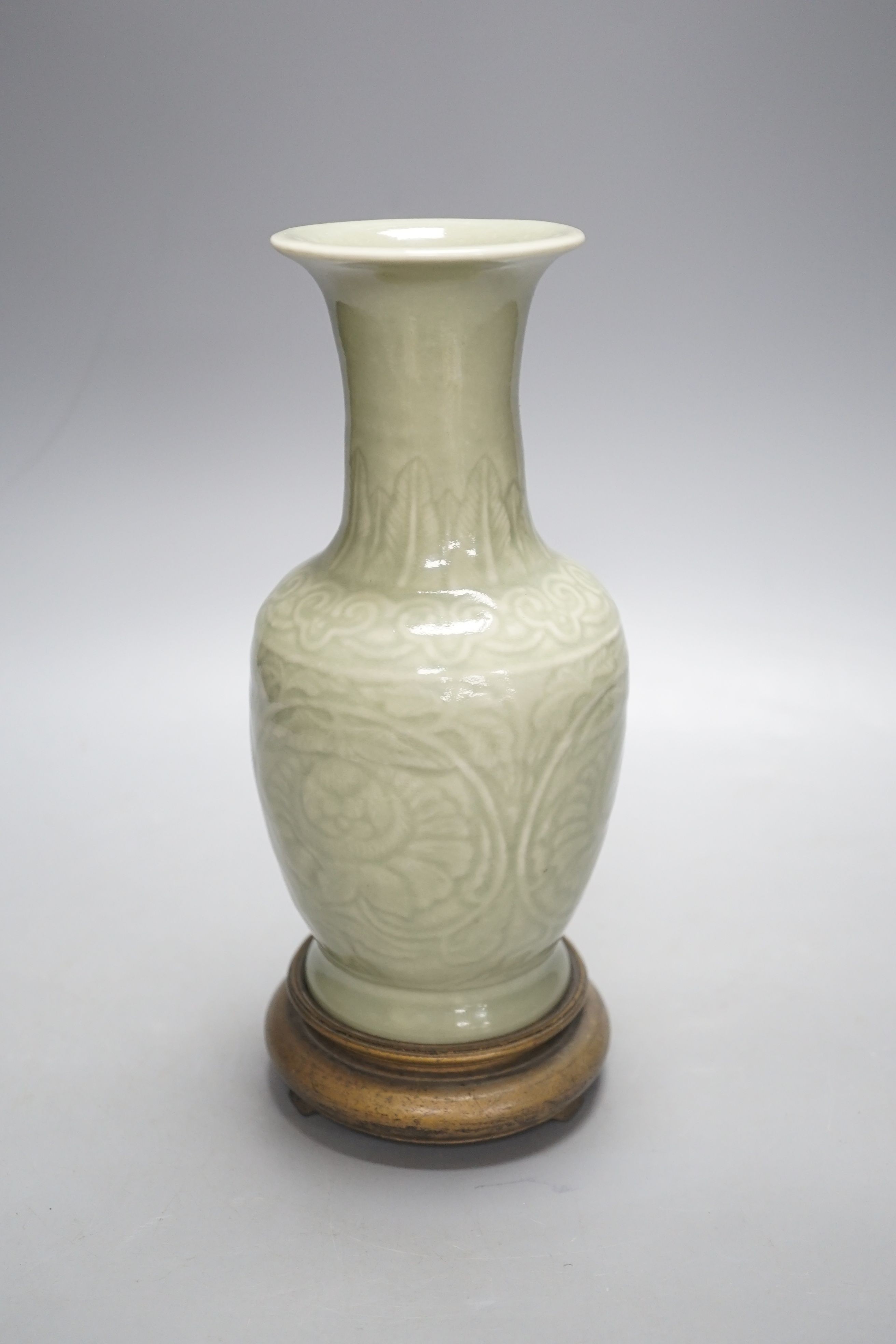 A Chinese celadon vase on stand, 24 cms high including stand.